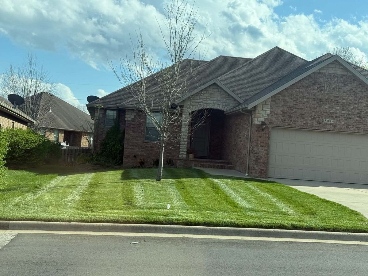 Brick home front lawn mowed for curb appeal