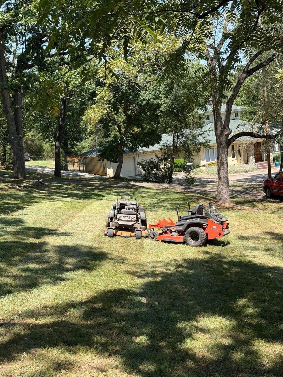 Mowers parked in the shade between jobs
